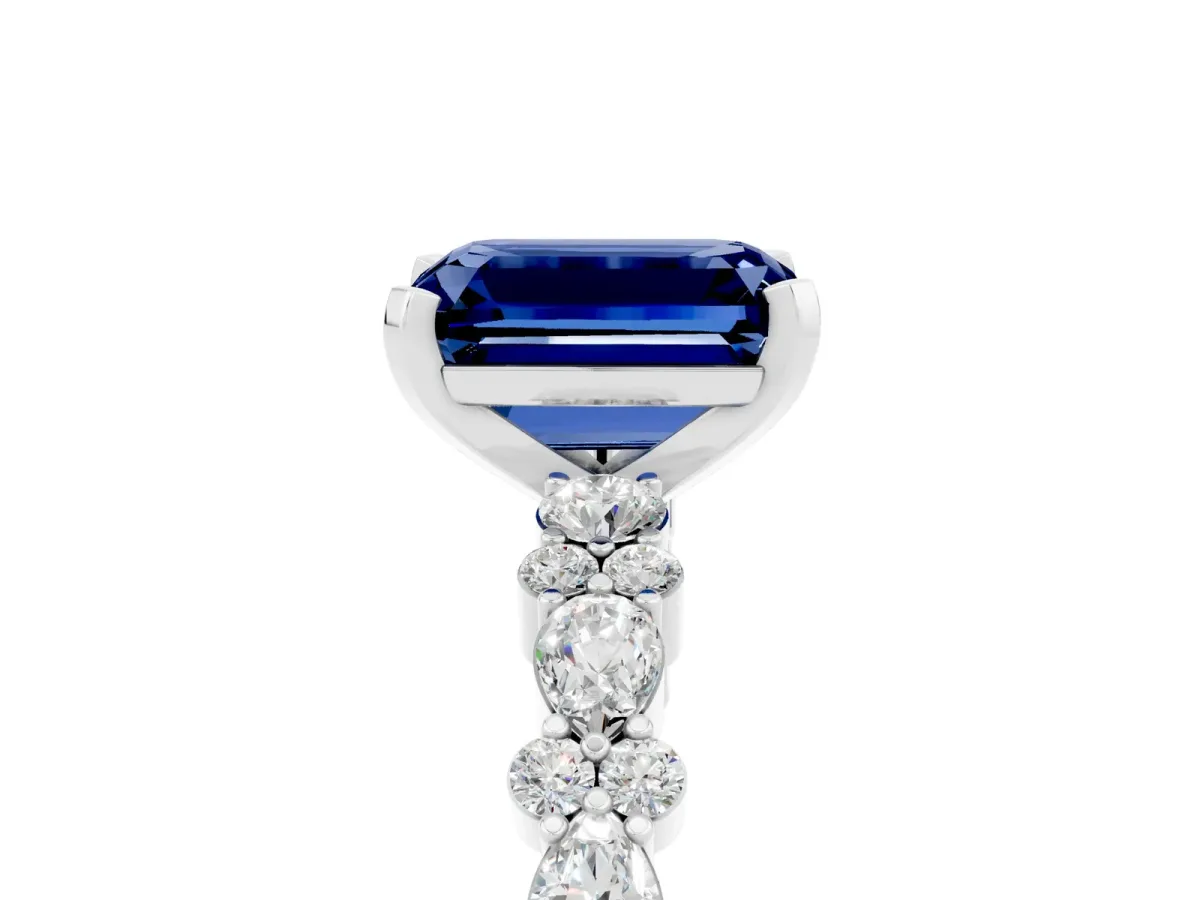 Emerald Cut Blue Sapphire Side Stone Solitaire Ring with Round and Four-Prong Setting White gold