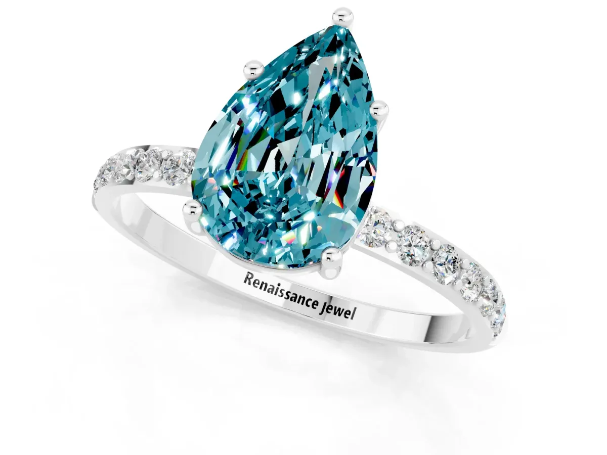 Pear Cut Blue Topaz Solitaire Ring with Round Pavé Band and Prong Setting Silver