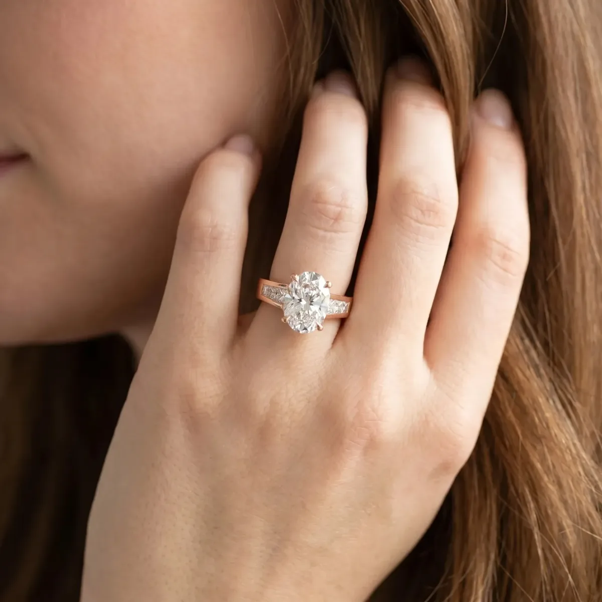 Oval Cut Cut Channel Set Solitaire Ring with Four-Prong Setting Rose gold