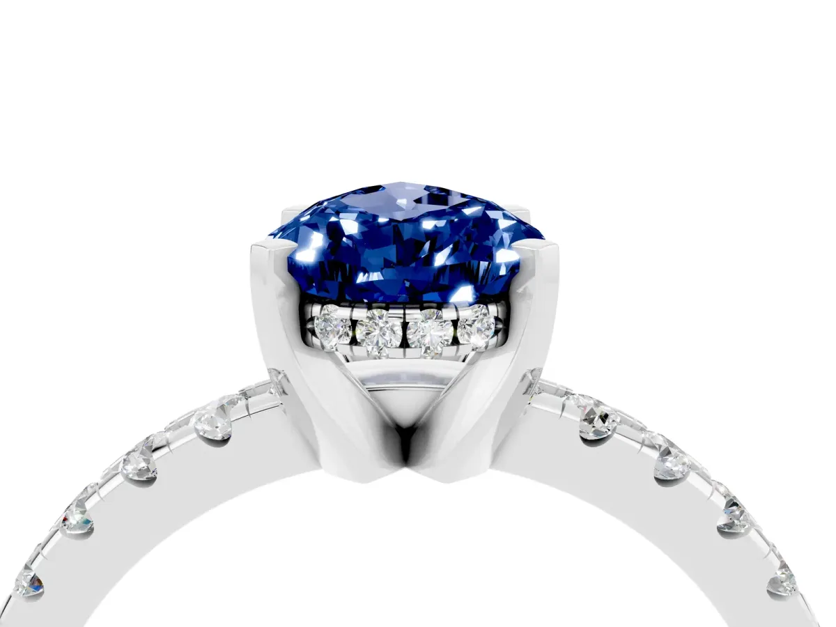 Pear Cut Blue Sapphire Solitaire Ring with Round Pavé Band and Four-Prong Setting Silver