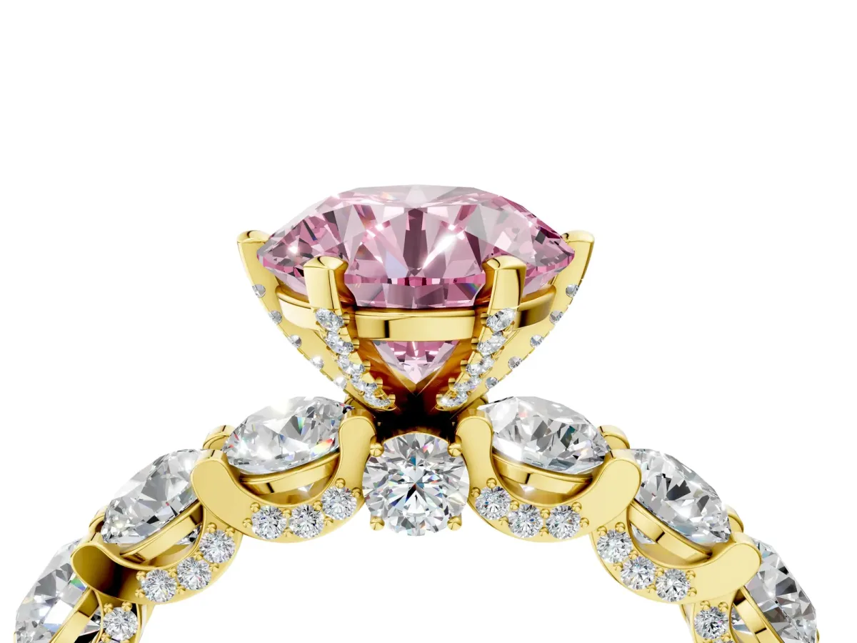 Fancy Pink Round Cut Diamond Side Stone Engagement Ring with Four-Prong Setting Yellow gold