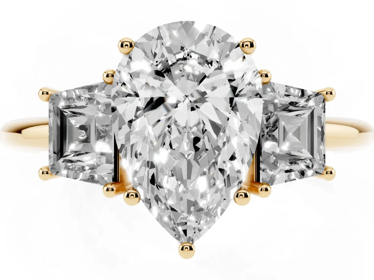 Pear Cut Diamond Three-Stone Ring with Trapezoid Side Stones and Prong Setting Yellow gold