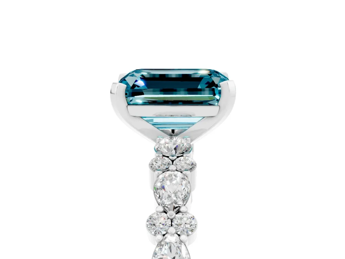 Emerald Cut Blue Topaz Side Stone Solitaire Ring with Round and Four-Prong Setting White gold