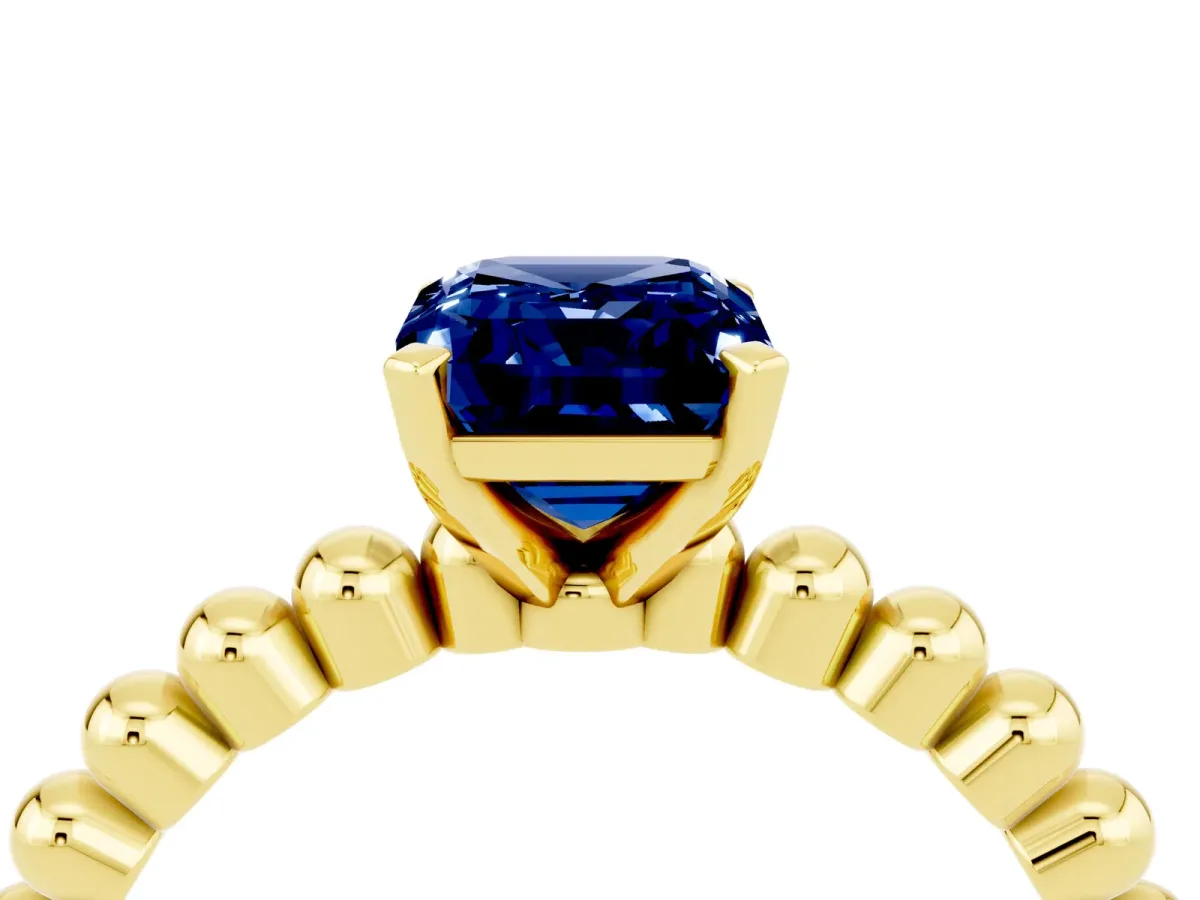 Emerald Cut Blue Sapphire Solitaire Ring with Beaded Band and Prong Setting Yellow gold