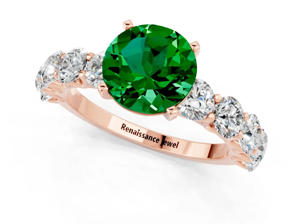 Round Cut Emerald Prong Setting with Side Stones on a Pave Band Rose gold