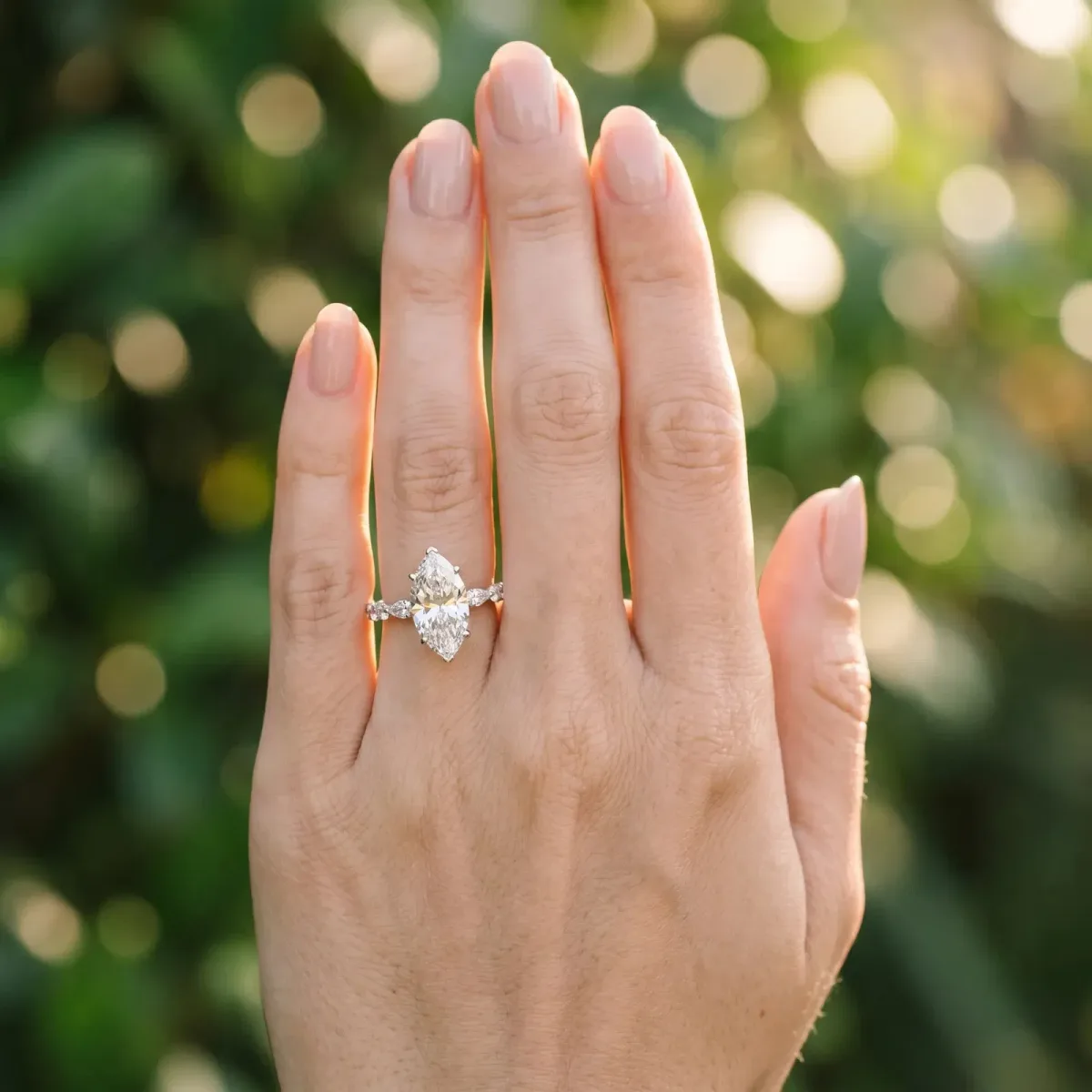 Marquise Cut Diamond Ring with Marquise and Round Side Stones and Four-Prong Setting Silver