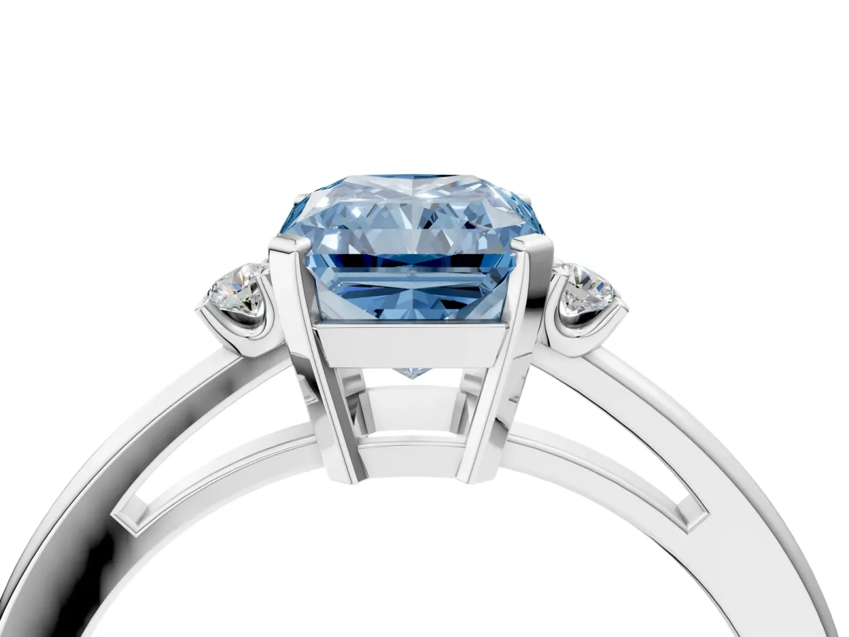 Fancy Blue Radiant Cut Cut Three-Stone Solitaire Ring with Round Accent Diamonds and Four-Prong Setting Platinum