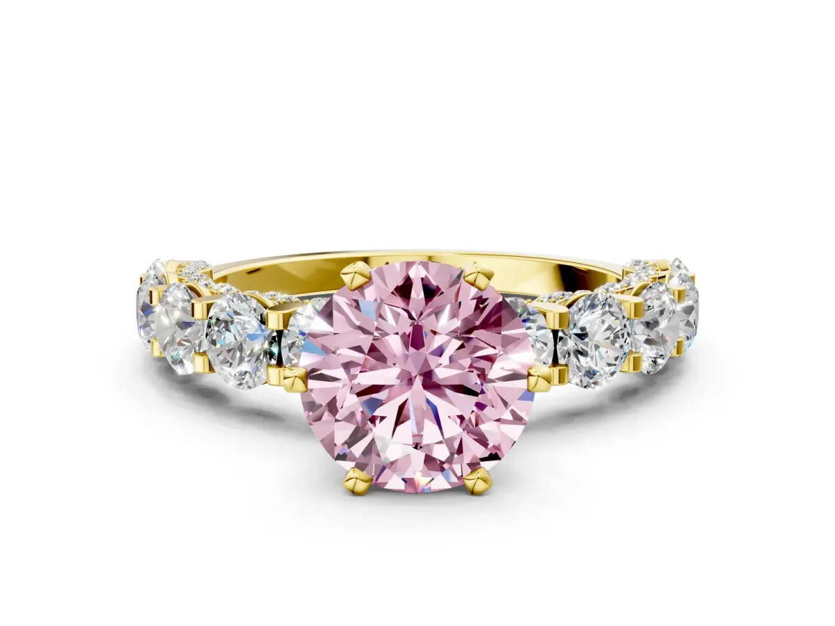 Fancy Pink Round Cut Diamond Side Stone Engagement Ring with Four-Prong Setting Yellow gold