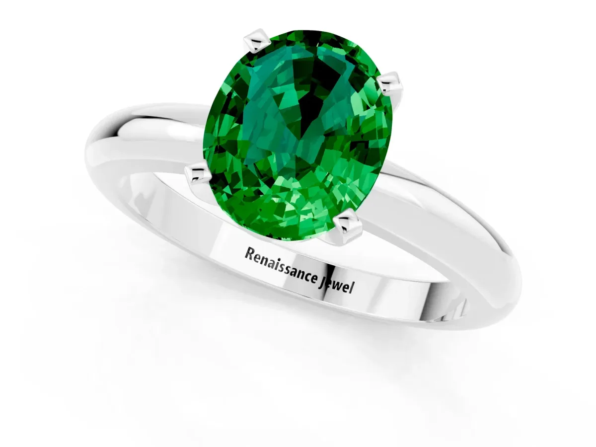 Oval Cut Emerald Solitaire Engagement Ring with Round Band and Four-Prong Setting Silver