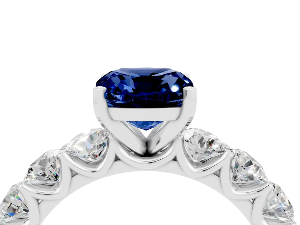 Cushion Cut Blue Sapphire Prong Setting with Side Stones on a Pave Band Silver