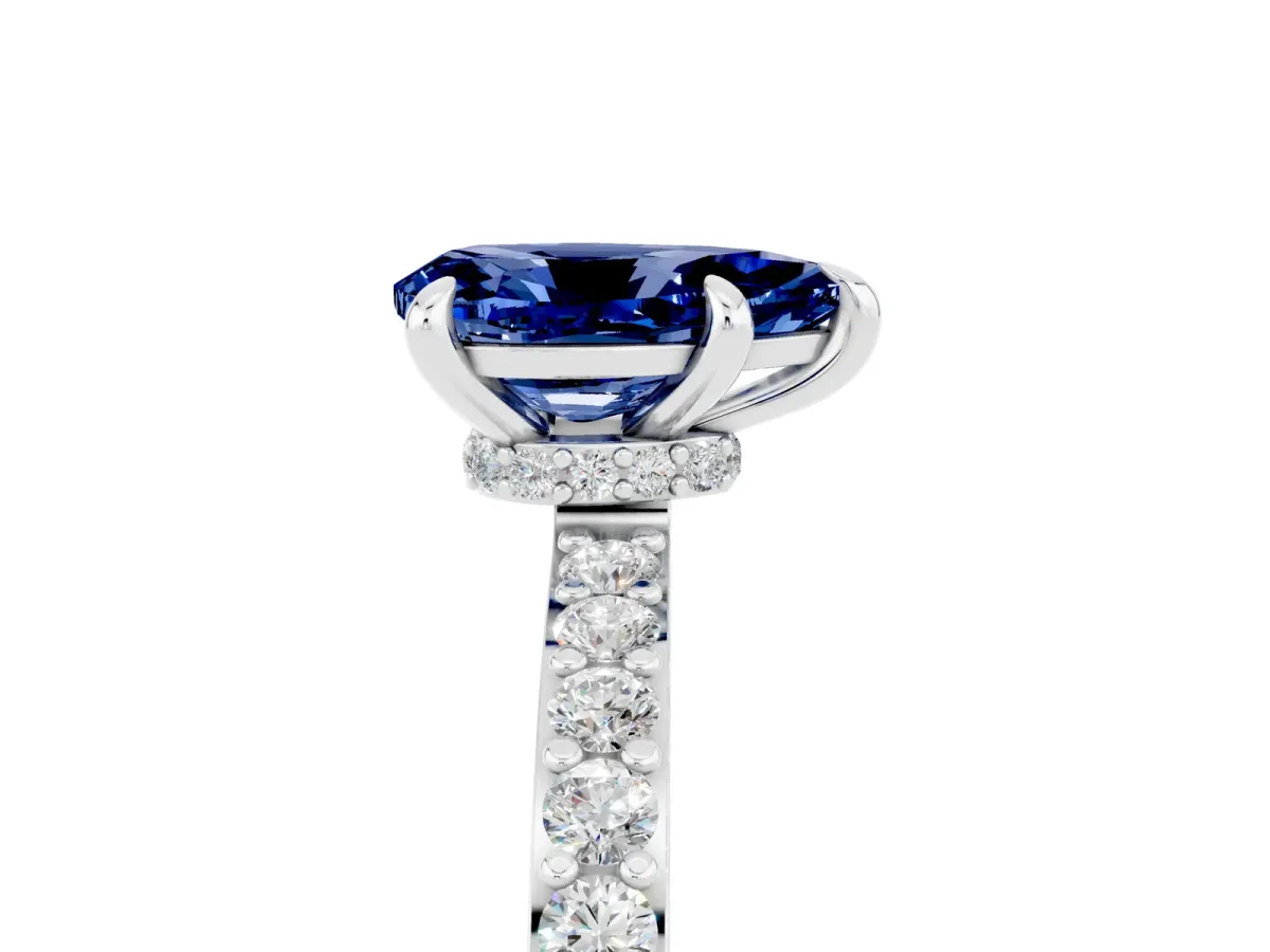 Pear Cut Blue Sapphire Solitaire Engagement Ring with Pavé Band and Four-Prong Setting Silver