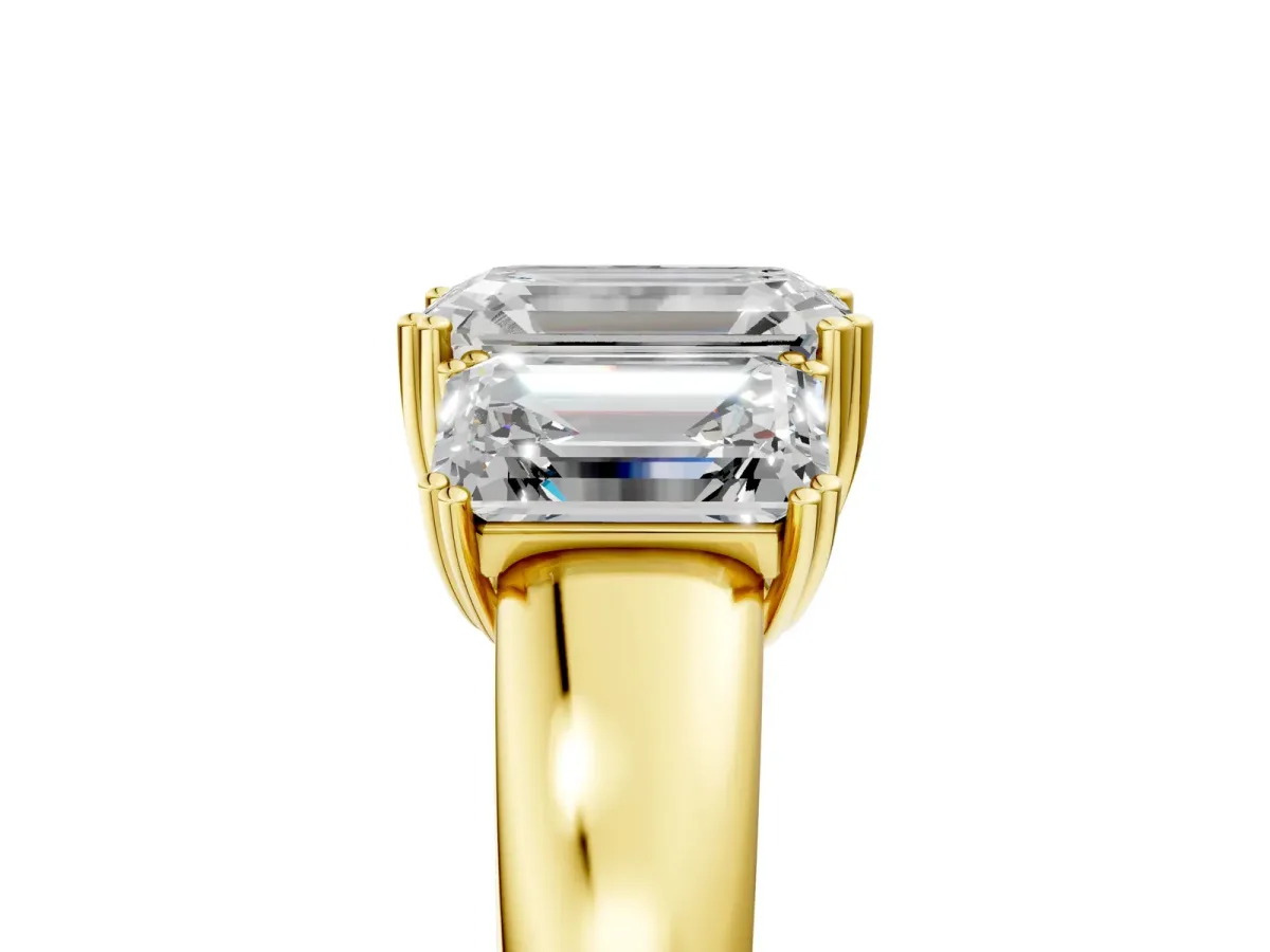 Three-Stone Emerald Cut Cut Diamond Ring with Channel Set Band and Four-Prong Setting Yellow gold