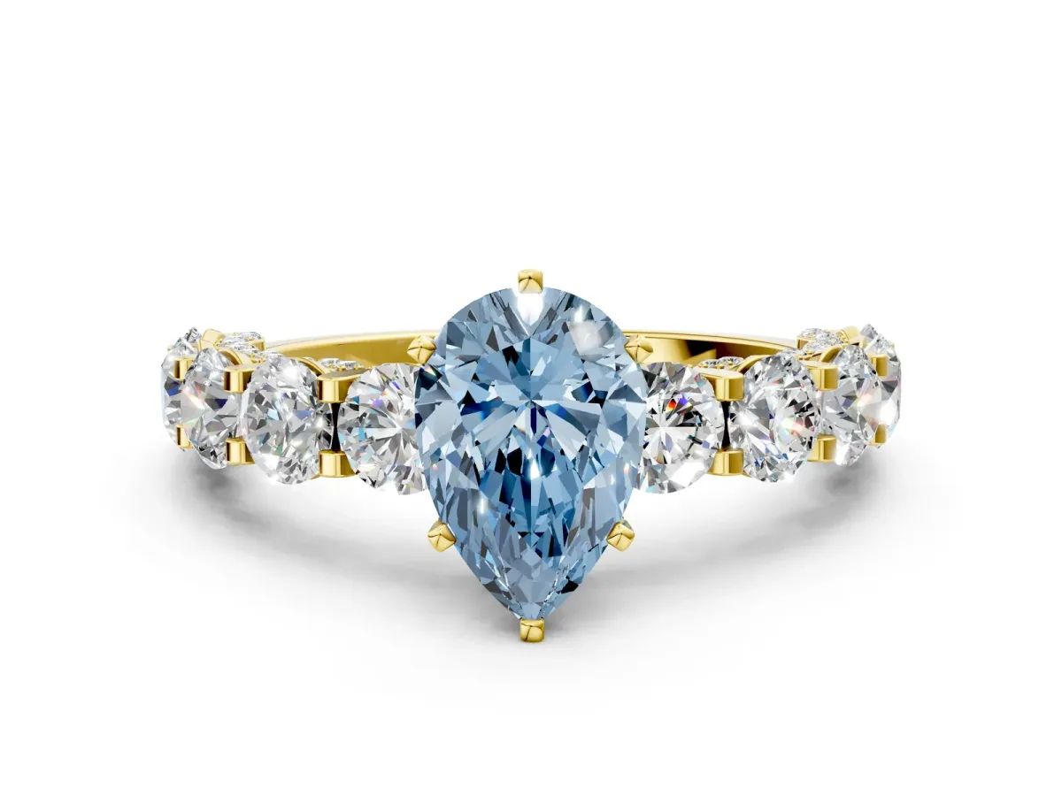 Fancy Blue Pear Cut Diamond Side Stone Engagement Ring with Four-Prong Setting Yellow gold