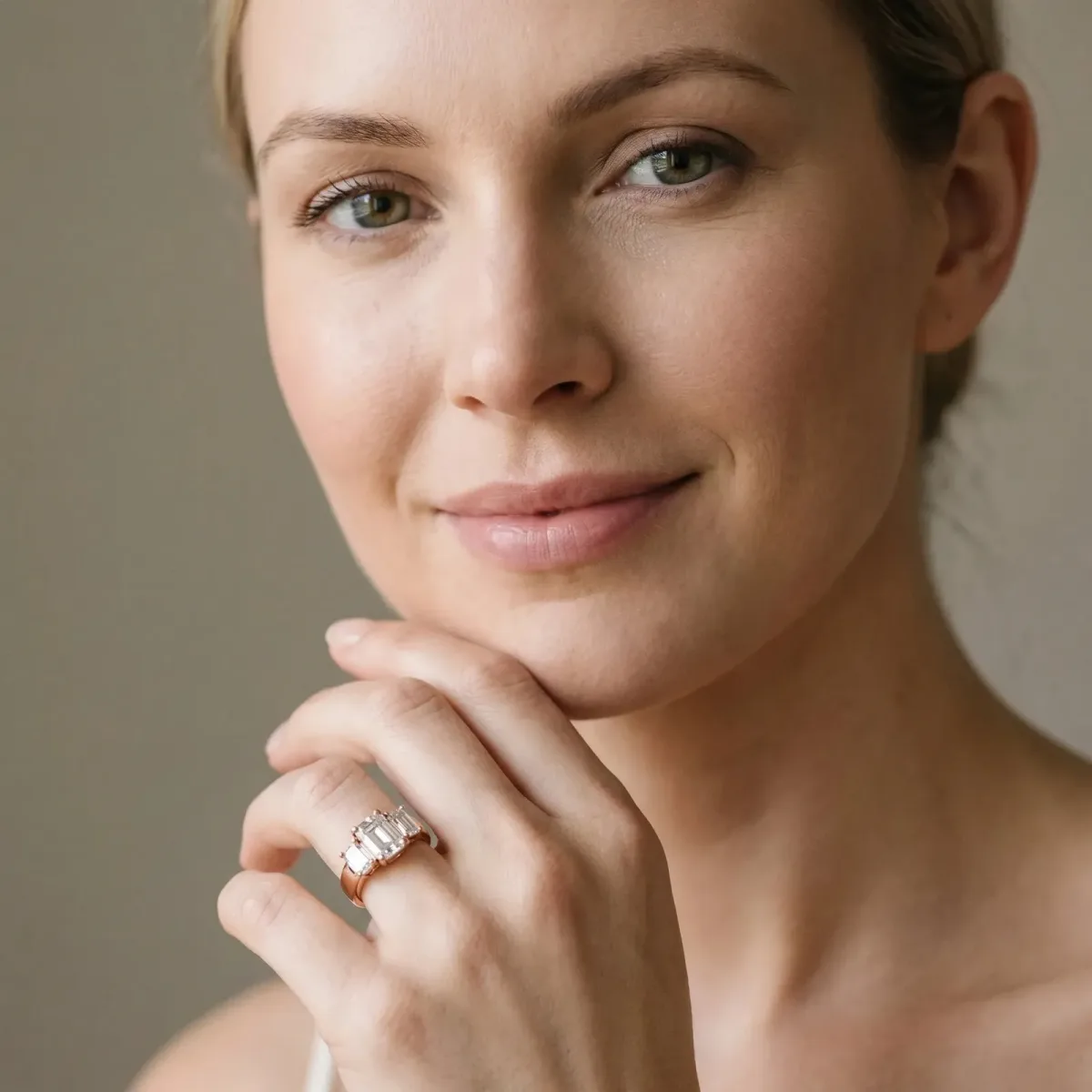 Three-Stone Emerald Cut Cut Diamond Ring with Channel Set Band and Four-Prong Setting Rose gold