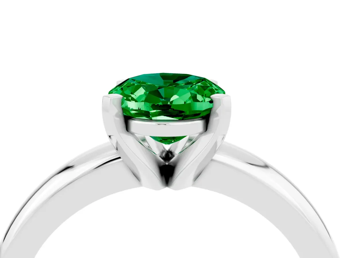 Oval Cut Emerald Solitaire Engagement Ring with Round Band and Four-Prong Setting Silver
