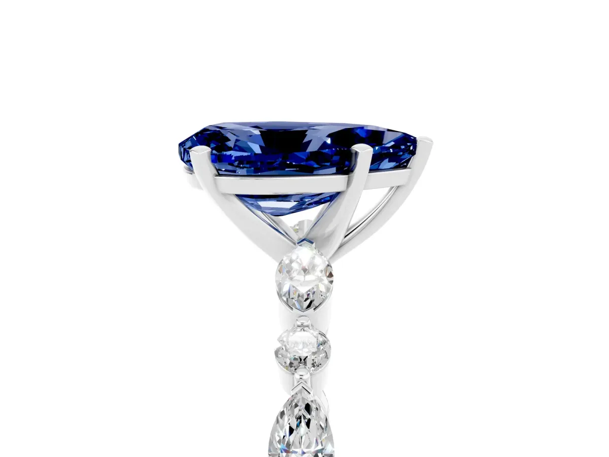 Pear Cut Blue Sapphire Ring with Marquise and Round Side Stones and Four-Prong Setting Silver