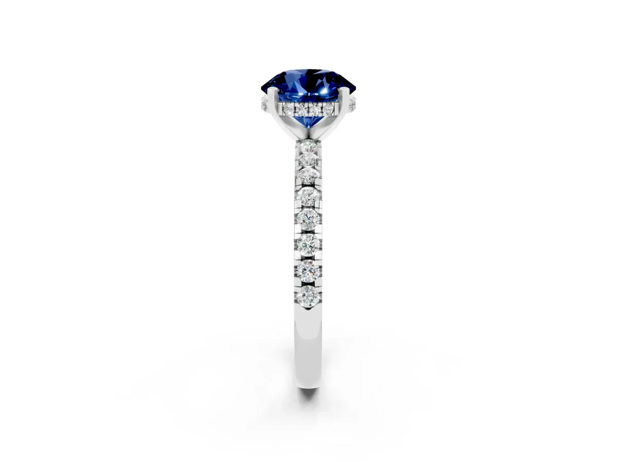 Round Cut Blue Sapphire Solitaire Ring with Round Pavé Band and Four-Prong Setting Silver
