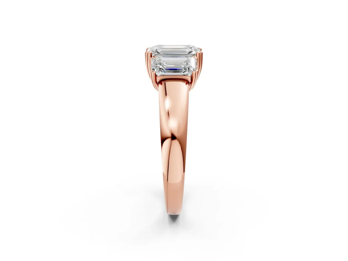 Three-Stone Emerald Cut Cut Diamond Ring with Channel Set Band and Four-Prong Setting Rose gold