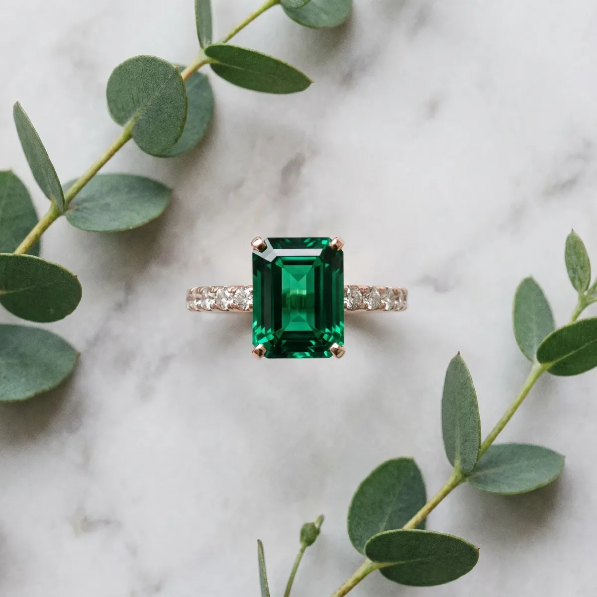 Emerald Cut Emerald Solitaire Ring with Round Pavé Band and Four-Prong Setting Rose gold