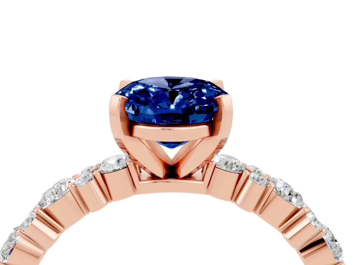 Oval Cut Blue Sapphire Side Stone Solitaire Ring with Round and Four-Prong Setting Rose gold