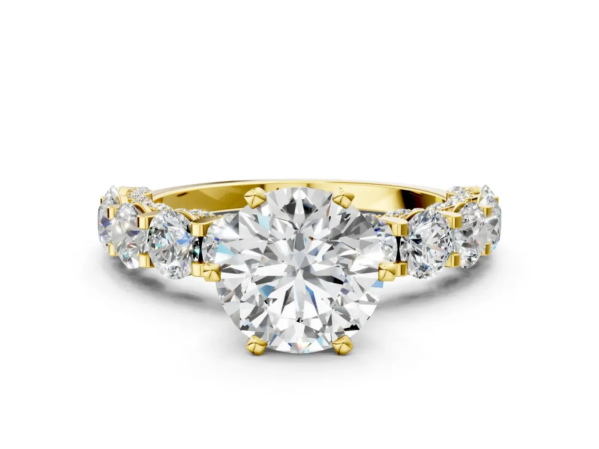 Round Cut Diamond Side Stone Engagement Ring with Four-Prong Setting Yellow gold