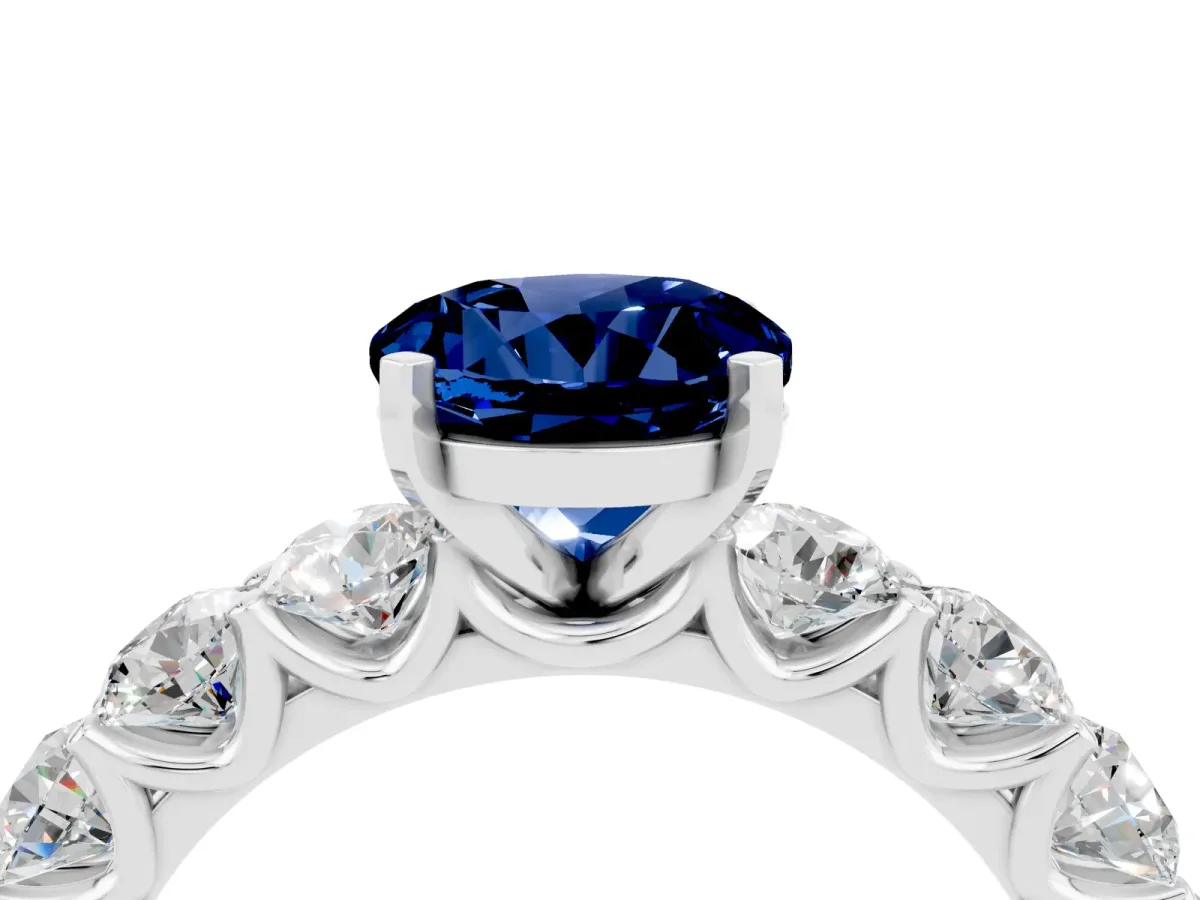 Round Cut Blue Sapphire Prong Setting with Side Stones on a Pave Band Platinum