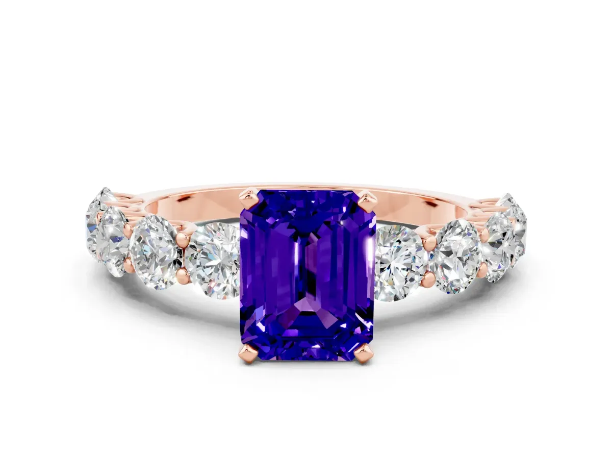 Emerald Cut Tanzanite Prong Setting with Side Stones on a Pave Band Rose gold