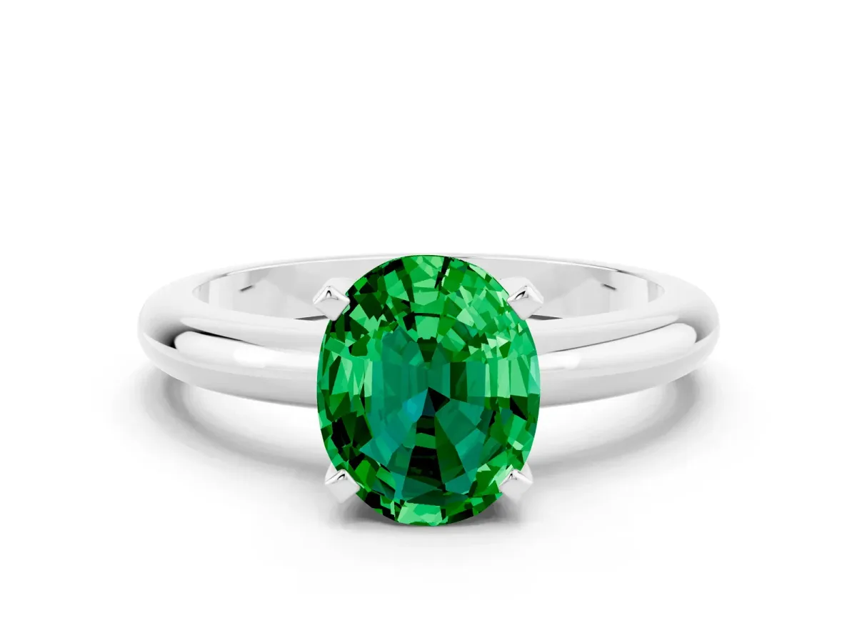 Oval Cut Emerald Solitaire Engagement Ring with Round Band and Four-Prong Setting Silver