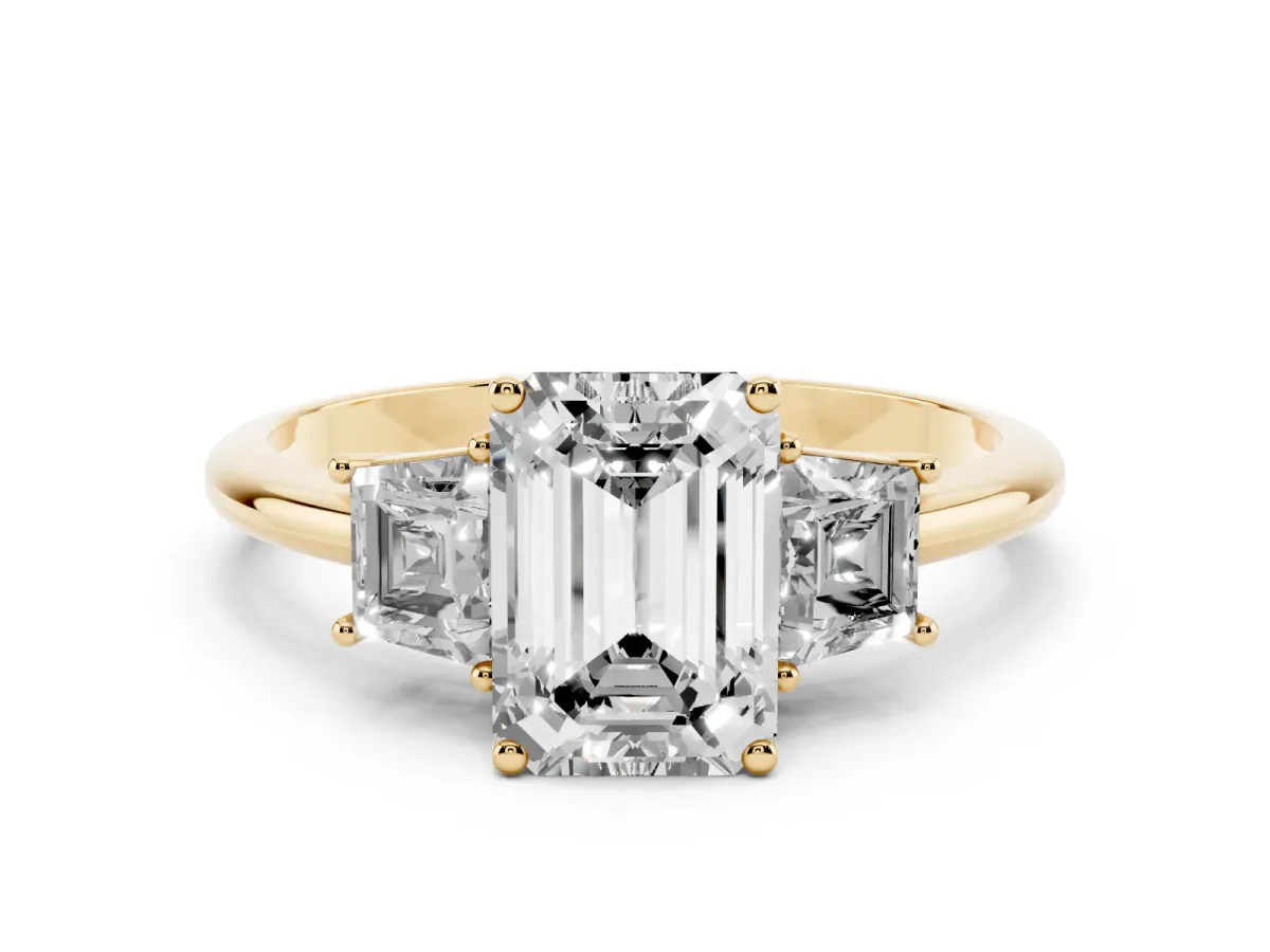 Emerald Cut Diamond Three-Stone Ring with Trapezoid Side Stones and Prong Setting Yellow gold