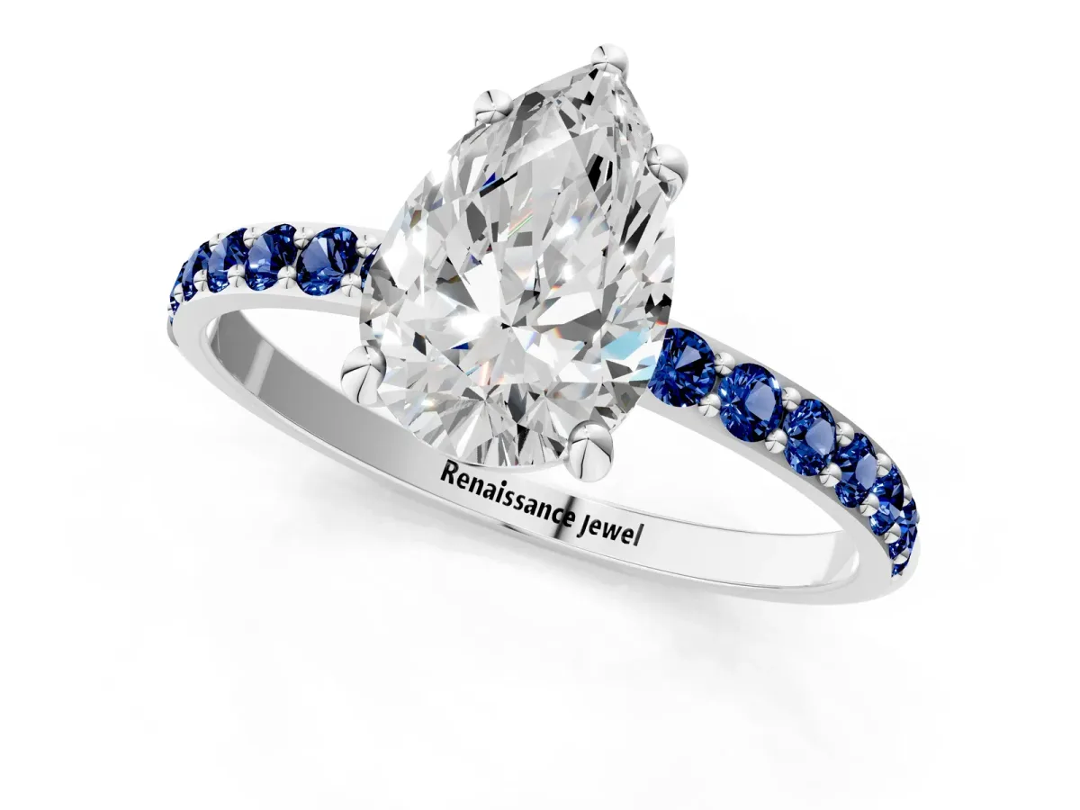 Pear Cut Diamond Solitaire Ring with Round Blue Sapphire Pavé Band and Prong Setting Silver