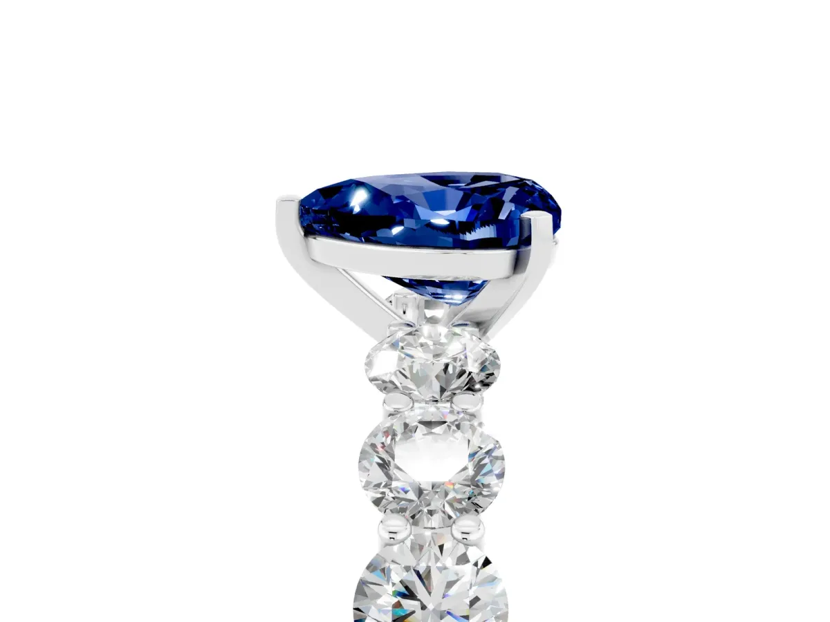 Heart Cut Blue Sapphire Prong Setting with Side Stones on a Pave Band Silver