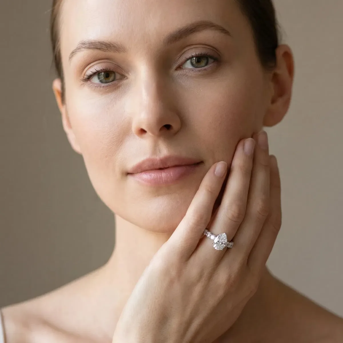 Pear Cut Diamond Prong Setting with Side Stones on a Pave Band Silver