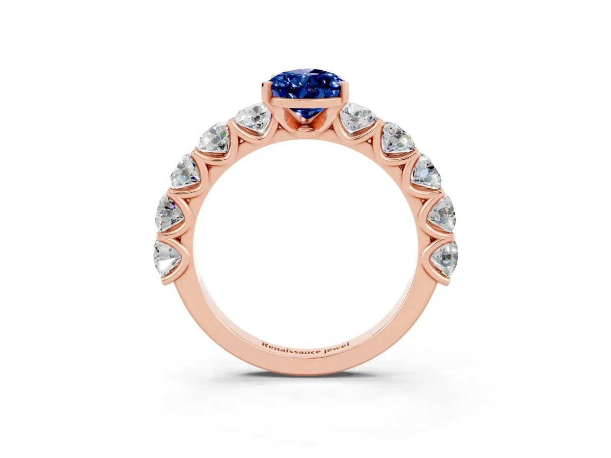 Pear Cut Blue Sapphire Prong Setting with Side Stones on a Pave Band Rose gold