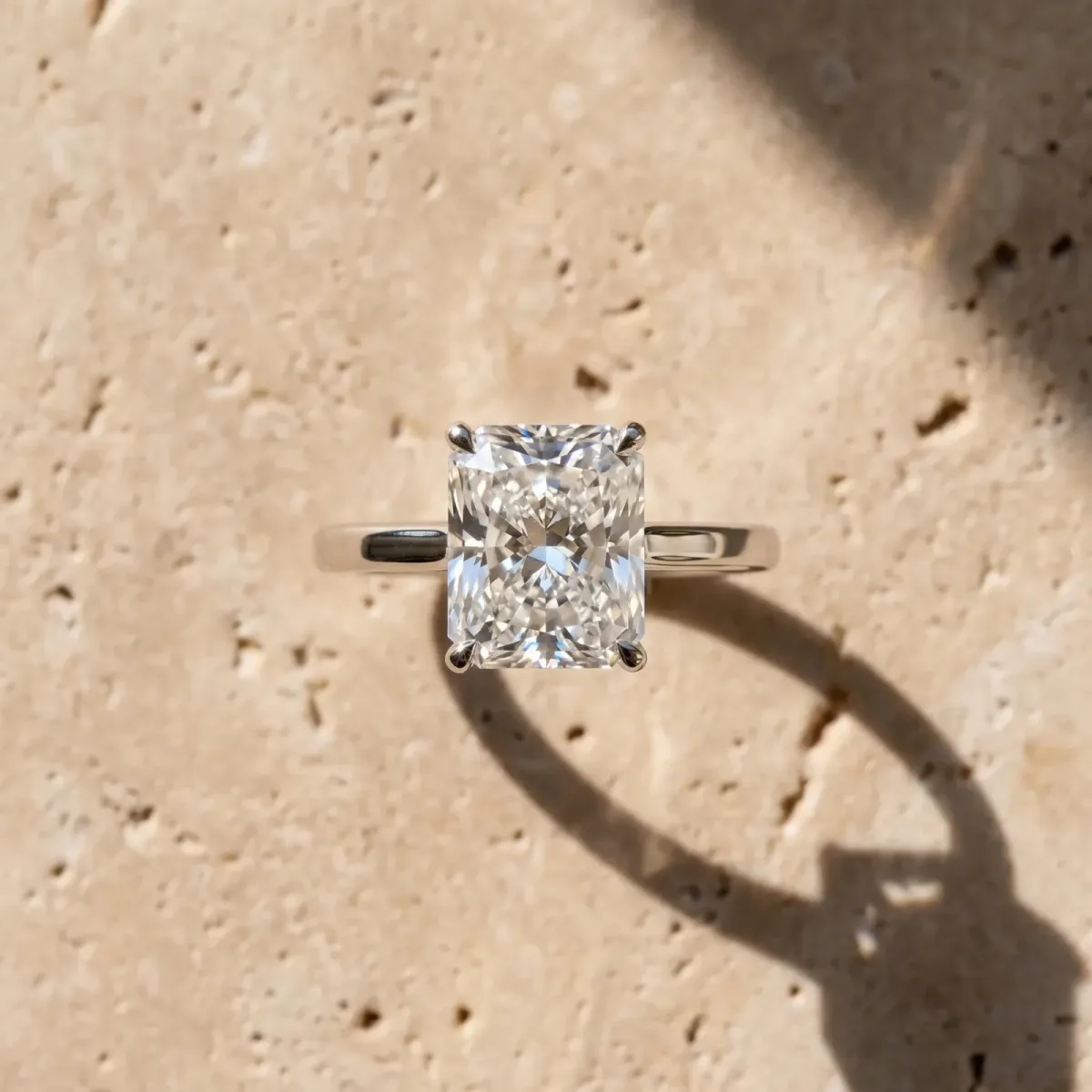 Radiant Cut Cut Solitaire Engagement Ring with Four-Prong Setting on a Classic Band Platinum