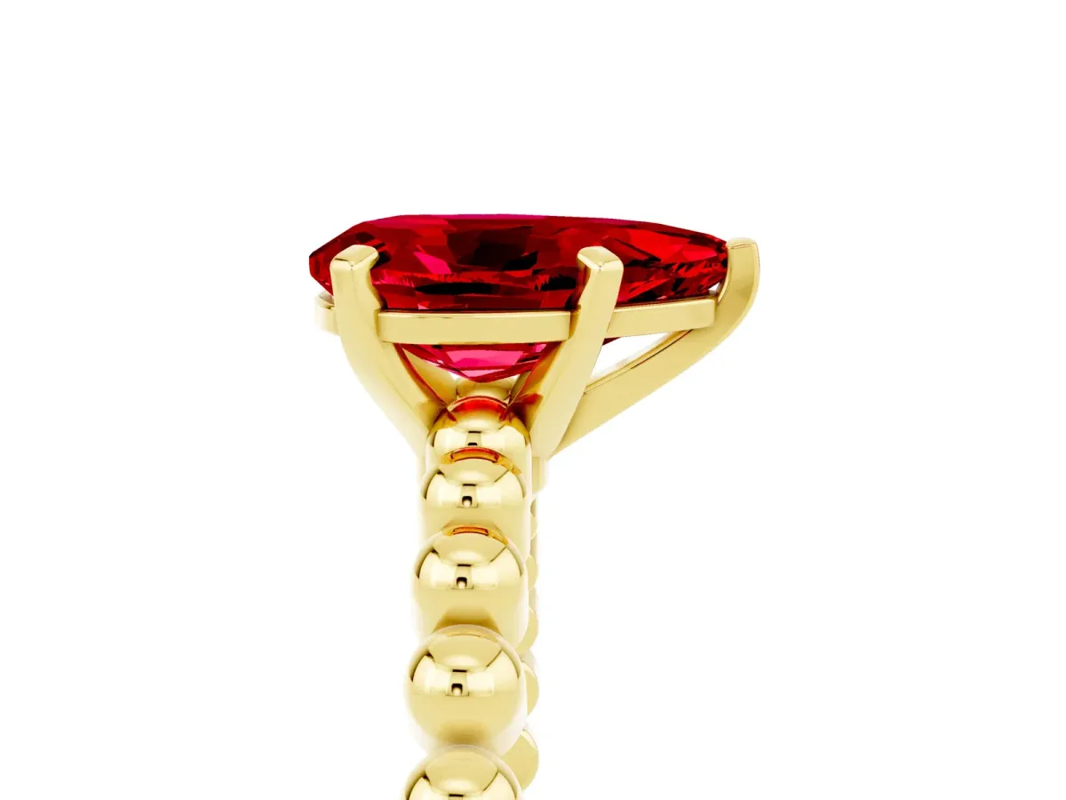 Pear Cut Ruby Solitaire Ring with Beaded Band and Prong Setting Yellow gold