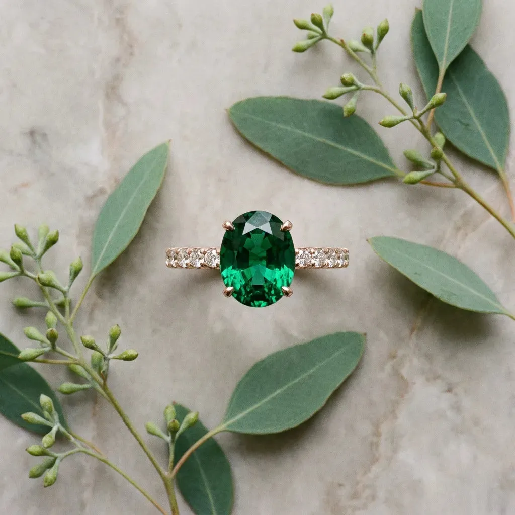 Oval Cut Emerald Solitaire Ring with Round Pavé Band and Four-Prong Setting Rose gold