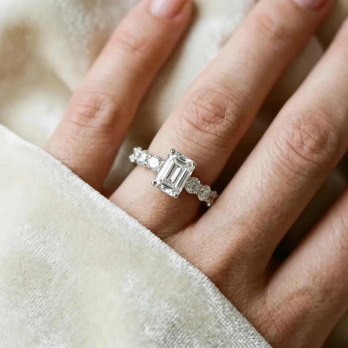 Emerald Cut Diamond Prong Setting with Side Stones on a Pave Band Platinum