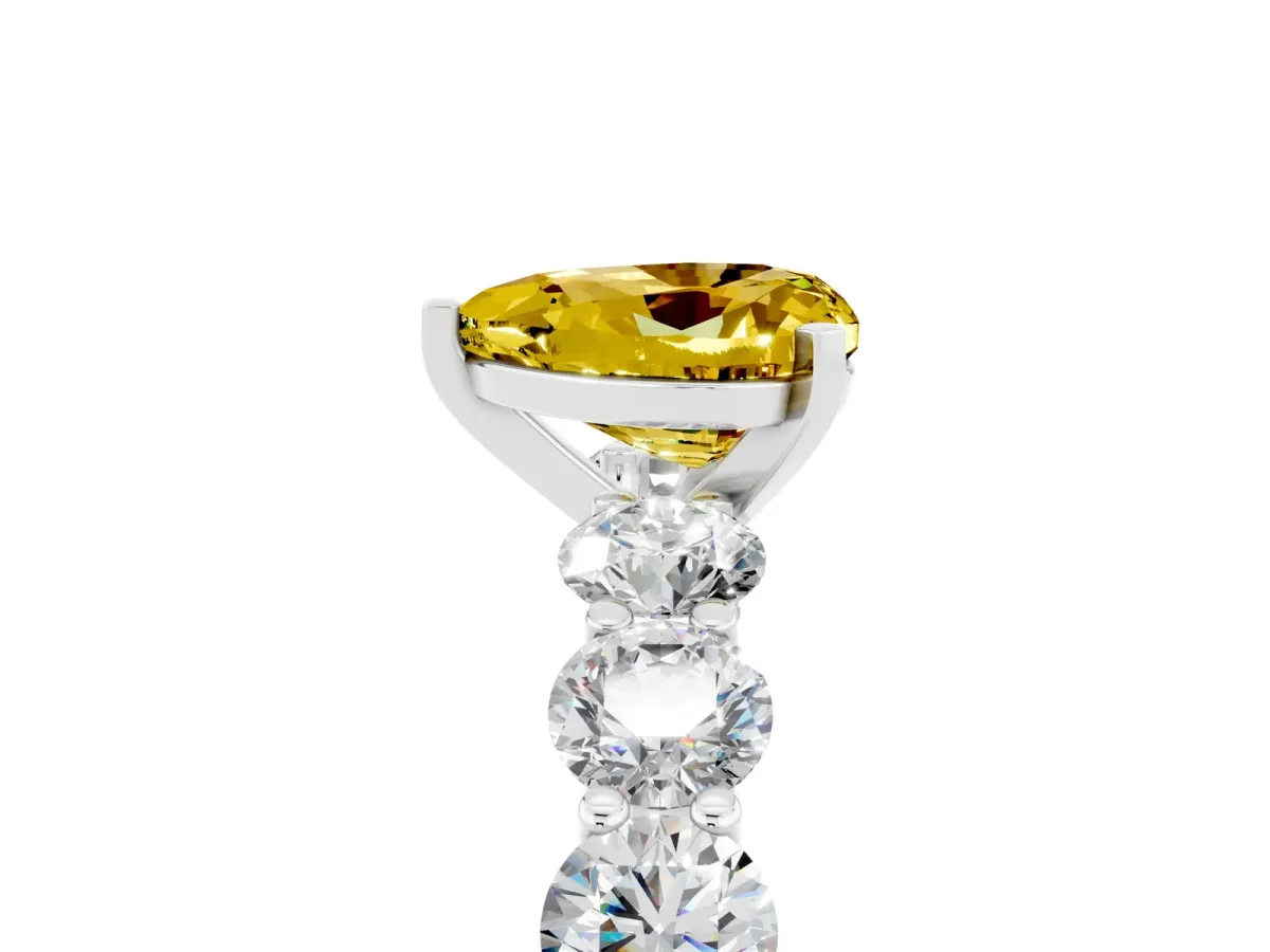 Heart Cut Yellow Sapphire Prong Setting with Side Stones on a Pave Band Silver