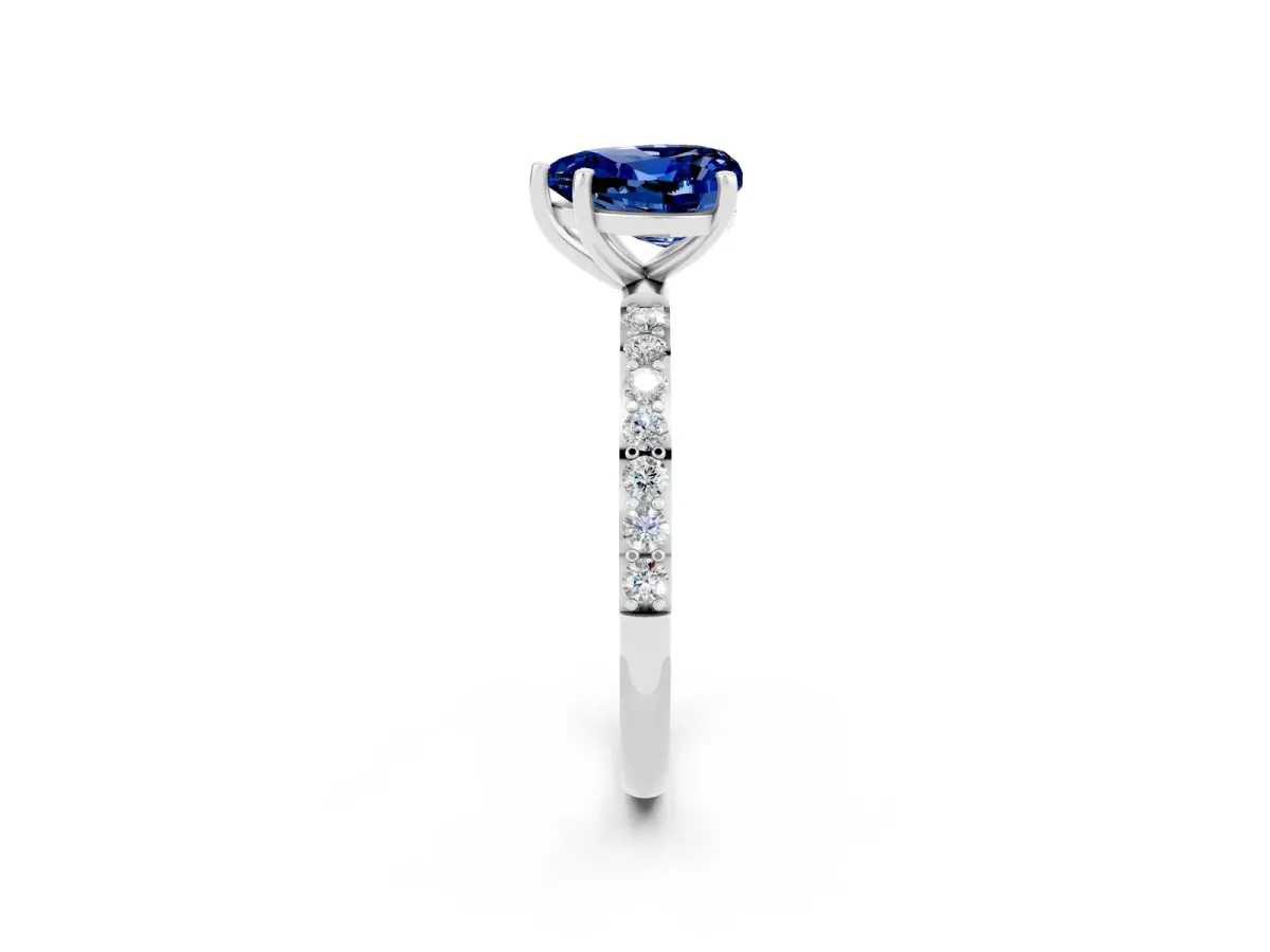 Heart Cut Blue Sapphire Solitaire Ring with Round Pavé Band and Prong Setting Silver