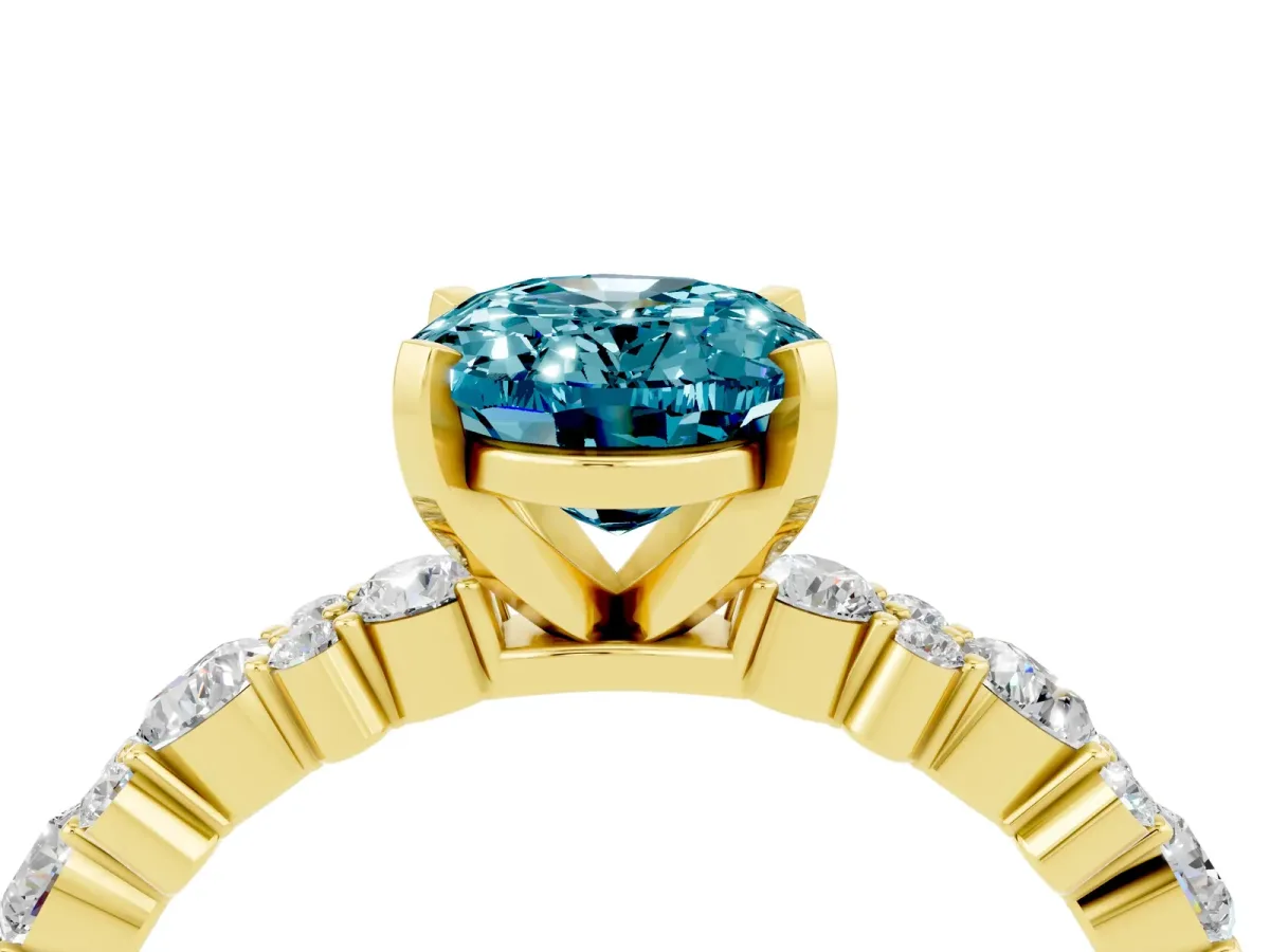 Oval Cut Blue Topaz Side Stone Solitaire Ring with Round and Four-Prong Setting Yellow gold