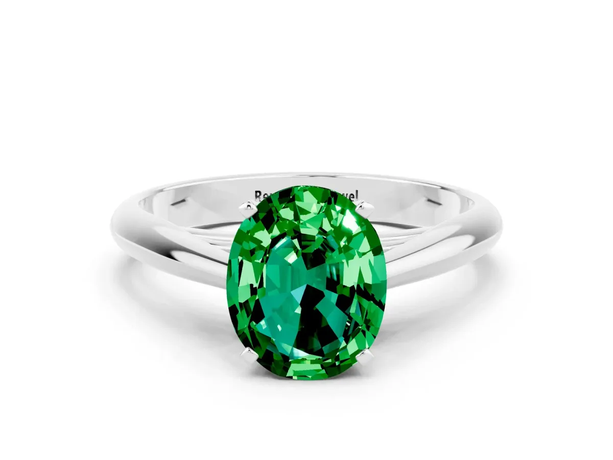Oval Cut Emerald Solitaire Engagement Ring with Cathedral Setting and Four-Prong Mount White gold