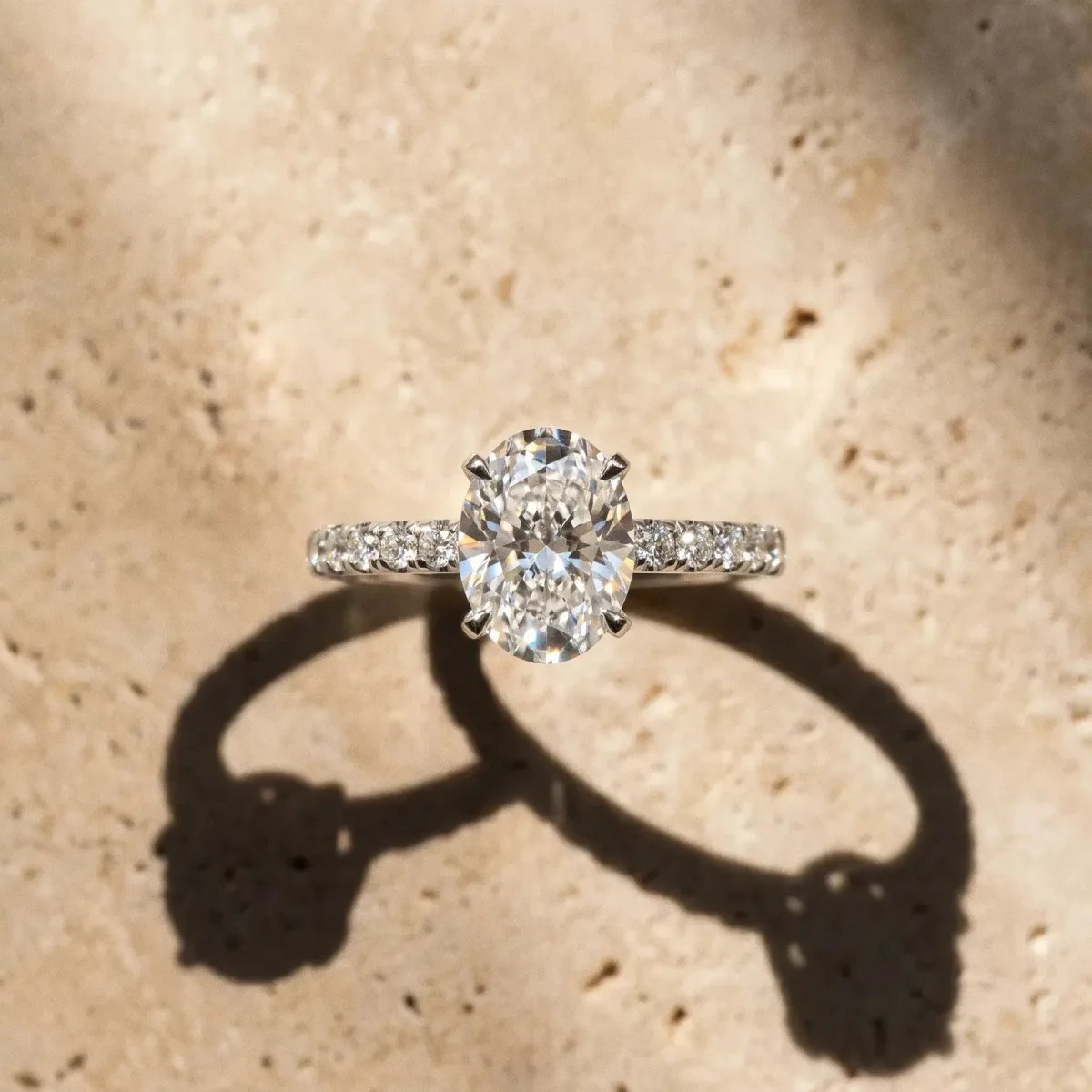 Oval Cut Diamond Solitaire Ring with Round Pavé Band and Four-Prong Setting Silver
