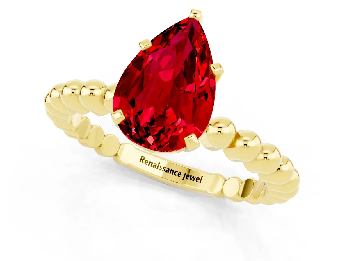 Pear Cut Ruby Solitaire Ring with Beaded Band and Prong Setting Yellow gold