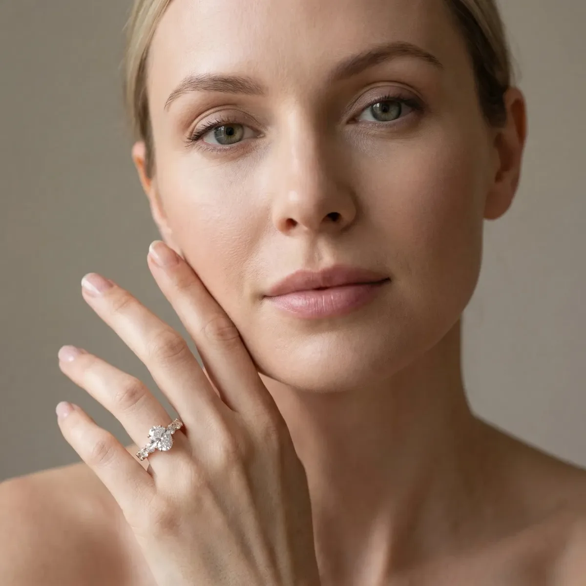 Oval Cut Diamond Prong Setting with Side Stones on a Pave Band Rose gold