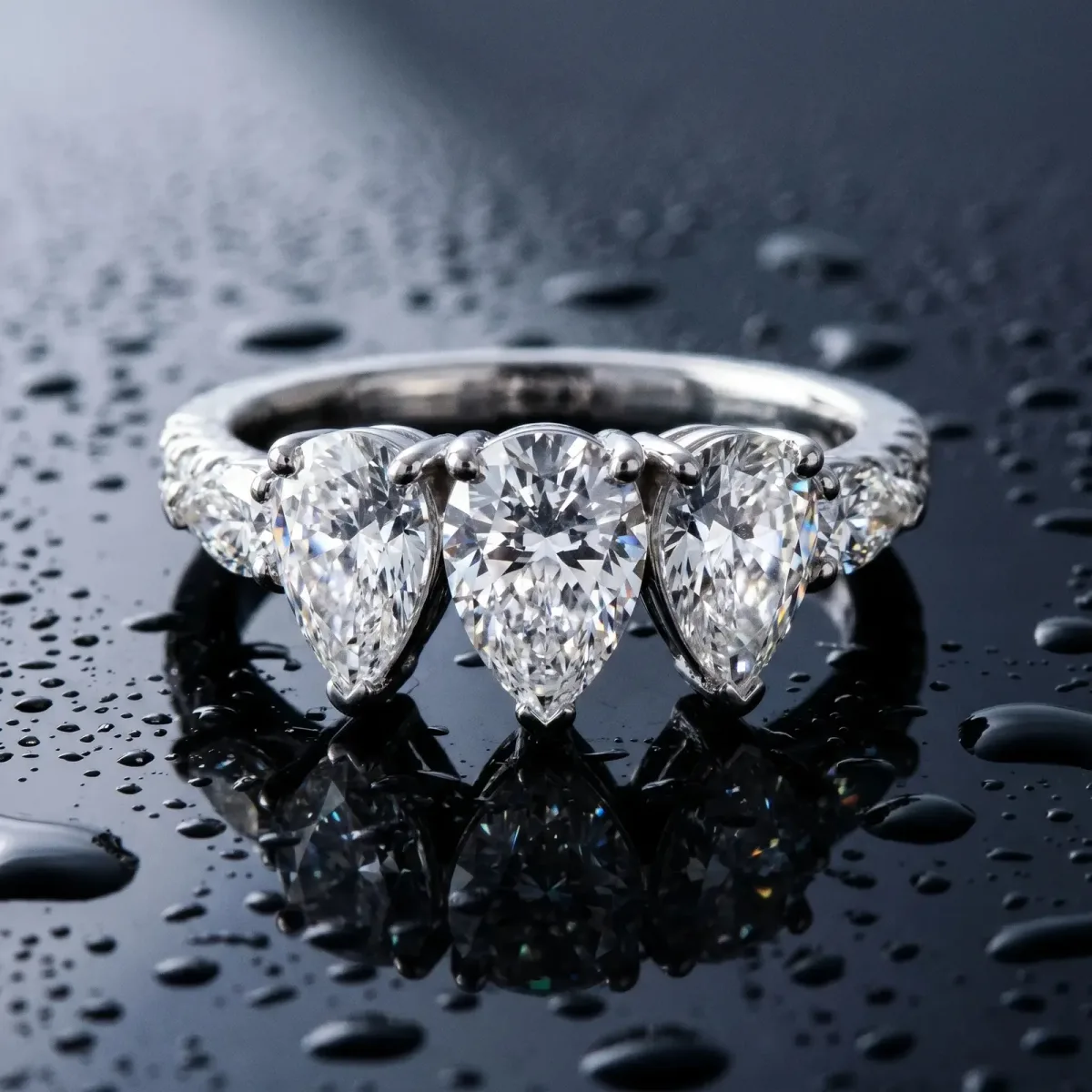 Pear Cut Brilliant Trilogy Channel Set Diamond Ring with Bar Prongs Platinum
