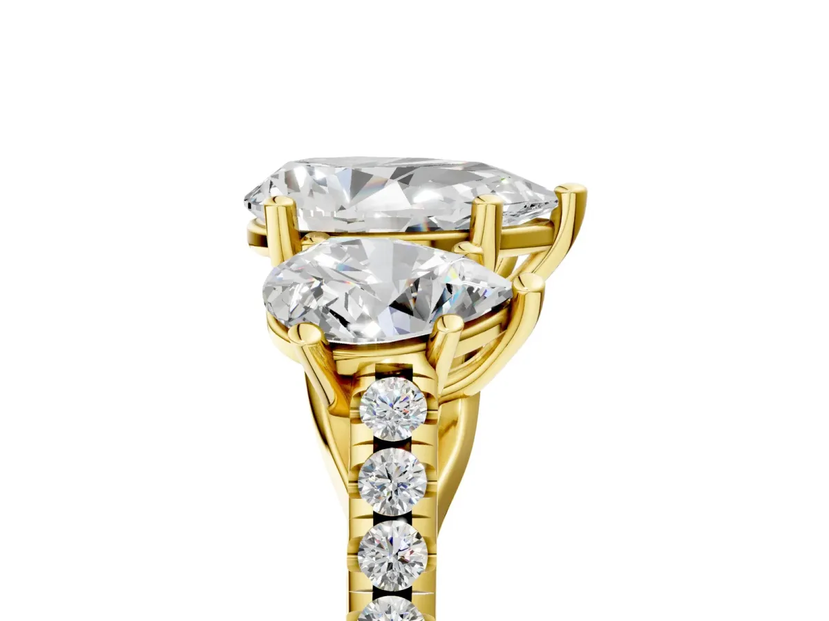 Three-Stone Pear Cut Diamond Ring with Round Pavé Band and Prong Setting Yellow gold