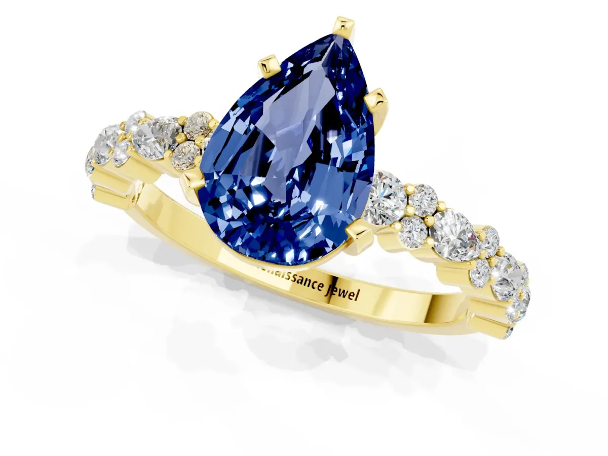 Pear Cut Blue Sapphire Side Stone Solitaire Ring with Round and Four-Prong Setting Yellow gold