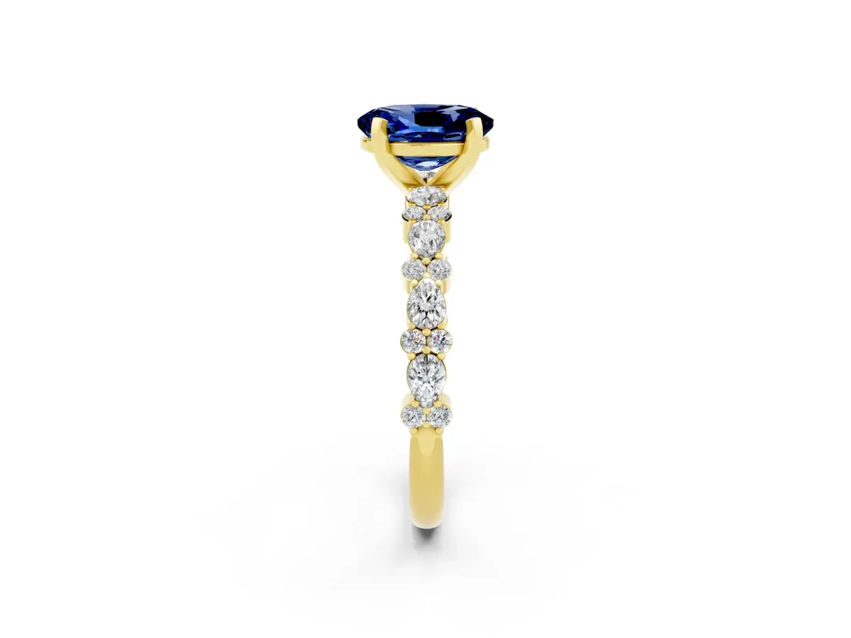 Oval Cut Blue Sapphire Side Stone Solitaire Ring with Round and Four-Prong Setting Yellow gold