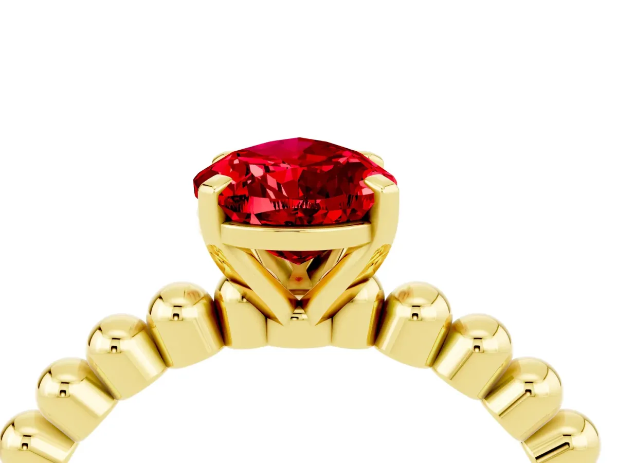 Pear Cut Ruby Solitaire Ring with Beaded Band and Prong Setting Yellow gold