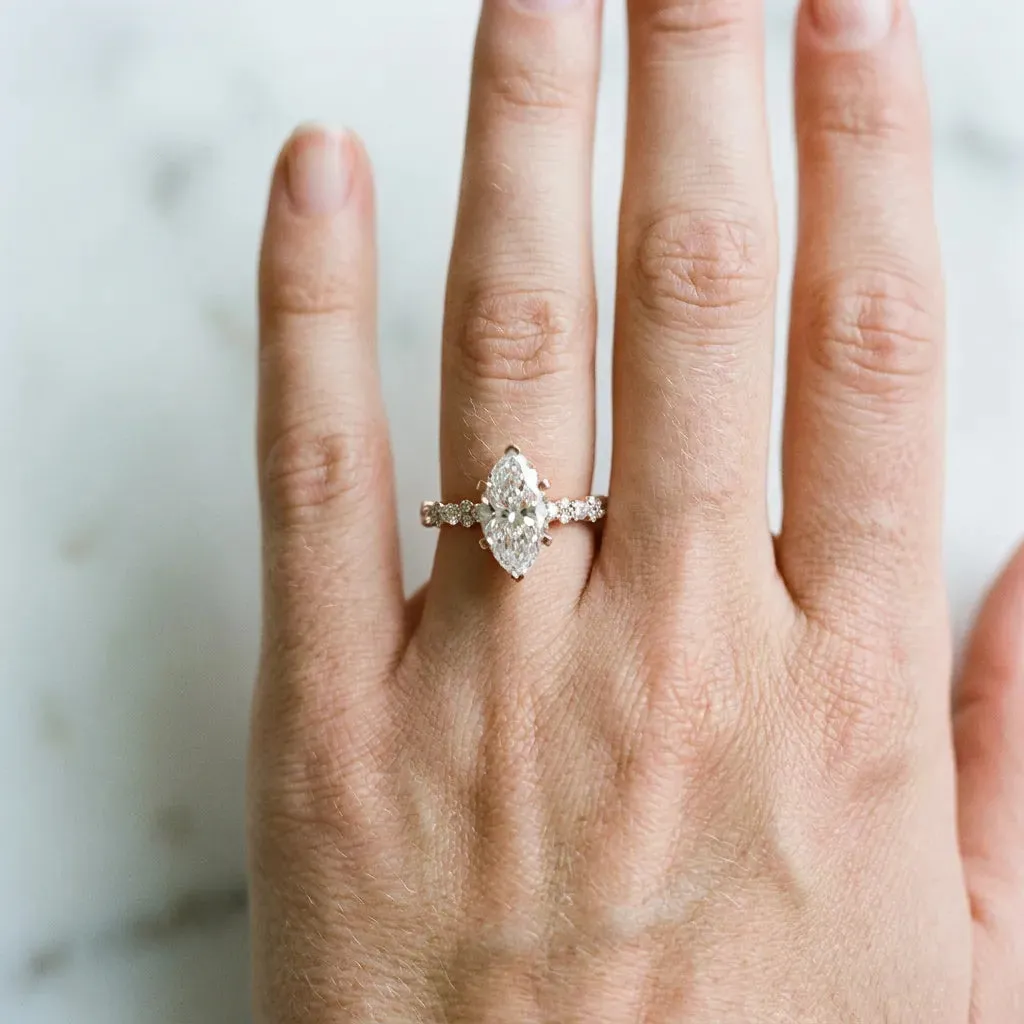 Marquise Cut Diamond Side Stone Solitaire Ring with Round and Four-Prong Setting Rose gold